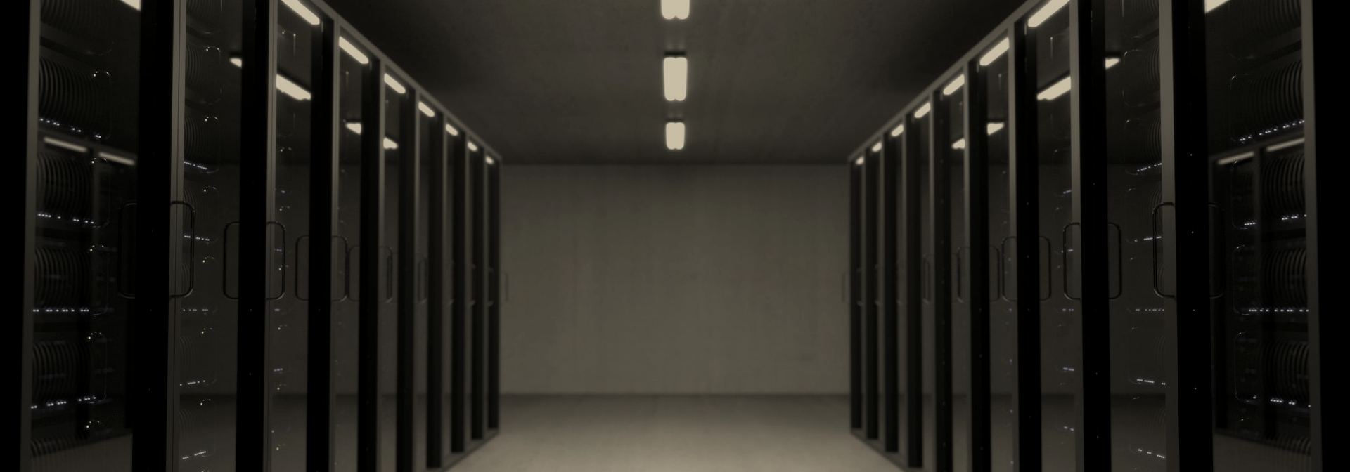 Rows of high-density racks in a darkened data hall